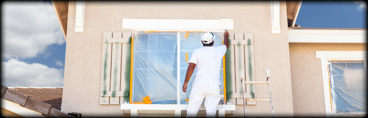 Man painting exterior of a house